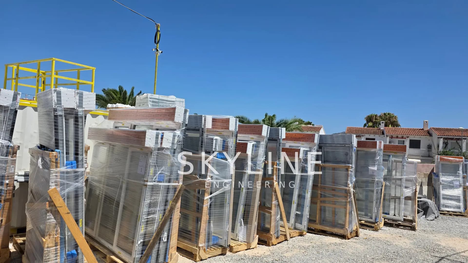 Pallets of aluminium window and door frames delivered to the Lanucia 6 site in La Nucía